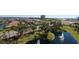 A beautiful aerial view overlooking lush landscaping, a lake with fountains, and waterfront homes at 501 Haben Blvd # 704, Palmetto, FL 34221