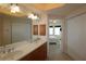 Bathroom featuring double sink vanity, tile floors and view to bedroom at 501 Haben Blvd # 704, Palmetto, FL 34221