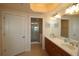 Bathroom with double sink vanity, mirrors, and a glass enclosed walk-in shower at 501 Haben Blvd # 704, Palmetto, FL 34221