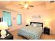 Inviting bedroom features a tray ceiling, ceiling fan, and windows with light turquoise curtains at 501 Haben Blvd # 704, Palmetto, FL 34221