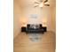 A bedroom featuring a futon with pillows, decorative lamps, and light-colored flooring at 501 Haben Blvd # 704, Palmetto, FL 34221