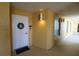 Condo entrance featuring a welcoming wreath, unit number, and ambient lighting at 501 Haben Blvd # 704, Palmetto, FL 34221