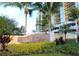Well-manicured entrance to The Palms at Cortez Dunes with lush landscaping and elegant signage at 501 Haben Blvd # 704, Palmetto, FL 34221