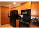 Well-lit kitchen features wood cabinets, granite countertops, and modern appliances at 501 Haben Blvd # 704, Palmetto, FL 34221