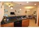 Open kitchen features dark granite countertops, stainless sink and bar top seating at 501 Haben Blvd # 704, Palmetto, FL 34221