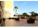Wide patio offers comfortable seating with palm tree views and sunny skies at 501 Haben Blvd # 704, Palmetto, FL 34221