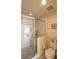 Tiled shower with glass door, storage and view to vanity and bedroom at 501 Haben Blvd # 704, Palmetto, FL 34221