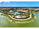 A beautiful aerial view of the community pool, clubhouse, and surrounding neighborhood at 5437 Manchini St, Sarasota, FL 34238