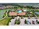 Aerial view of the community clubhouse, pool, and parking area, all beautifully landscaped at 5437 Manchini St, Sarasota, FL 34238