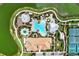 Overhead view of community pools, tennis courts, clubhouse, and walking paths, beautifully landscaped at 5437 Manchini St, Sarasota, FL 34238