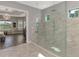 A primary bath featuring a glass enclosed shower and a view of the bedroom at 5437 Manchini St, Sarasota, FL 34238