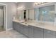 A serene bathroom with double vanity, a large mirror, and marble floors at 5437 Manchini St, Sarasota, FL 34238