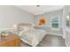 Comfortable bedroom with luxury bedding, a decorative art piece, and a stylish light fixture at 5437 Manchini St, Sarasota, FL 34238