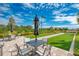Inviting bocce ball court with manicured green turf, surrounded by tropical plants and comfortable patio seating at 5437 Manchini St, Sarasota, FL 34238