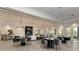 A modern common area featuring table seating, plush chairs, and natural light at 5437 Manchini St, Sarasota, FL 34238