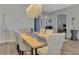 Bright dining space featuring unique light fixture, elegant chairs, and artful decor at 5437 Manchini St, Sarasota, FL 34238