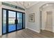 Stylish foyer boasts wood flooring, designer lighting, and access to the bathroom at 5437 Manchini St, Sarasota, FL 34238