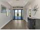 Elegant foyer with modern chandelier, wood floors, and stylish decor at 5437 Manchini St, Sarasota, FL 34238