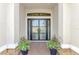 Elegant front entry featuring stylish double doors and decorative planters at 5437 Manchini St, Sarasota, FL 34238