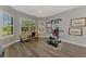 Home gym with large windows, exercise equipment, and a desk for a workspace at 5437 Manchini St, Sarasota, FL 34238