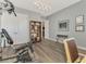 Home gym with exercise equipment, modern lighting, and a bookcase at 5437 Manchini St, Sarasota, FL 34238