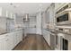 Well-appointed kitchen with stainless steel appliances, gray cabinets, and a large island with granite countertops at 5437 Manchini St, Sarasota, FL 34238