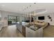 View of open kitchen and great room featuring a spacious island and seamless indoor/outdoor living at 5437 Manchini St, Sarasota, FL 34238