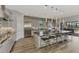 Spacious kitchen featuring an oversized center island with seating, stainless steel appliances, and access to the outdoor space at 5437 Manchini St, Sarasota, FL 34238