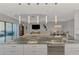 Open concept kitchen with granite countertops, a large island and a view of the living and dining areas at 5437 Manchini St, Sarasota, FL 34238