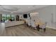 Bright living area with modern lighting, wood floors, and a view of the pool at 5437 Manchini St, Sarasota, FL 34238