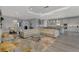 Spacious living area with leather furniture, modern kitchen view, and elegant lighting fixtures at 5437 Manchini St, Sarasota, FL 34238