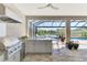 An outdoor kitchen provides modern amenities, scenic views, and a seamless transition to the pool area at 5437 Manchini St, Sarasota, FL 34238