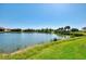 Picturesque view of a tranquil pond surrounded by meticulously maintained lawns and neighboring homes in a peaceful community at 5437 Manchini St, Sarasota, FL 34238