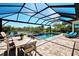 Enjoy the pool with screened enclosure, lounge chairs, and views of the surrounding landscape and lake at 5437 Manchini St, Sarasota, FL 34238