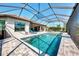 Pool featuring a screened enclosure, seamless access to outdoor kitchen, and comfortable lounge seating at 5437 Manchini St, Sarasota, FL 34238