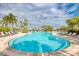 Expansive community pool with lounge chairs and shade structures, perfect for relaxation at 5437 Manchini St, Sarasota, FL 34238
