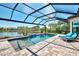Relax and unwind in the pool with a screened enclosure, comfortable lounge chairs, and scenic lake views at 5437 Manchini St, Sarasota, FL 34238