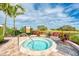 Intimate spa pool with tropical landscaping and serene green view in the background at 5437 Manchini St, Sarasota, FL 34238