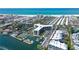 Beautiful aerial view of waterfront condos featuring a private marina, tennis courts, and beach access at 5855 Midnight Pass Rd # 512, Sarasota, FL 34242