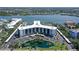 Aerial shot of condos with a pond, tennis courts, and water access, offering a relaxing environment at 5855 Midnight Pass Rd # 512, Sarasota, FL 34242