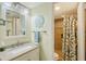 This bath has a large vanity, and a lovely walk-in shower with designer tile and a shower curtain at 5855 Midnight Pass Rd # 512, Sarasota, FL 34242