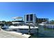 Luxurious boat docked, with the condo in the background, showing the community's upscale amenities at 5855 Midnight Pass Rd # 512, Sarasota, FL 34242