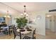 Dining area with a round table and modern light fixture, located off the kitchen at 5855 Midnight Pass Rd # 512, Sarasota, FL 34242