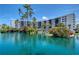 A waterfront condo building with a beautifully landscaped pond featuring a waterfall at 5855 Midnight Pass Rd # 512, Sarasota, FL 34242
