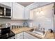Updated kitchen with stainless steel appliances and granite countertops at 5855 Midnight Pass Rd # 512, Sarasota, FL 34242