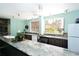 Large communal kitchen featuring a long marble countertop and ample cabinet space at 5855 Midnight Pass Rd # 512, Sarasota, FL 34242