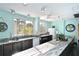Bright communal kitchen with a large countertop, stainless steel sink, and modern appliances at 5855 Midnight Pass Rd # 512, Sarasota, FL 34242
