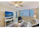 Bright living room featuring a ceiling fan and large window with shutter blinds at 5855 Midnight Pass Rd # 512, Sarasota, FL 34242