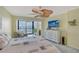 Bedroom with a ceiling fan, sliding glass doors leading to a balcony, and natural light at 5855 Midnight Pass Rd # 512, Sarasota, FL 34242