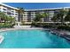 Resort style pool and jacuzzi surrounded by tropical landscaping and lounge chairs for relaxation at 5855 Midnight Pass Rd # 512, Sarasota, FL 34242